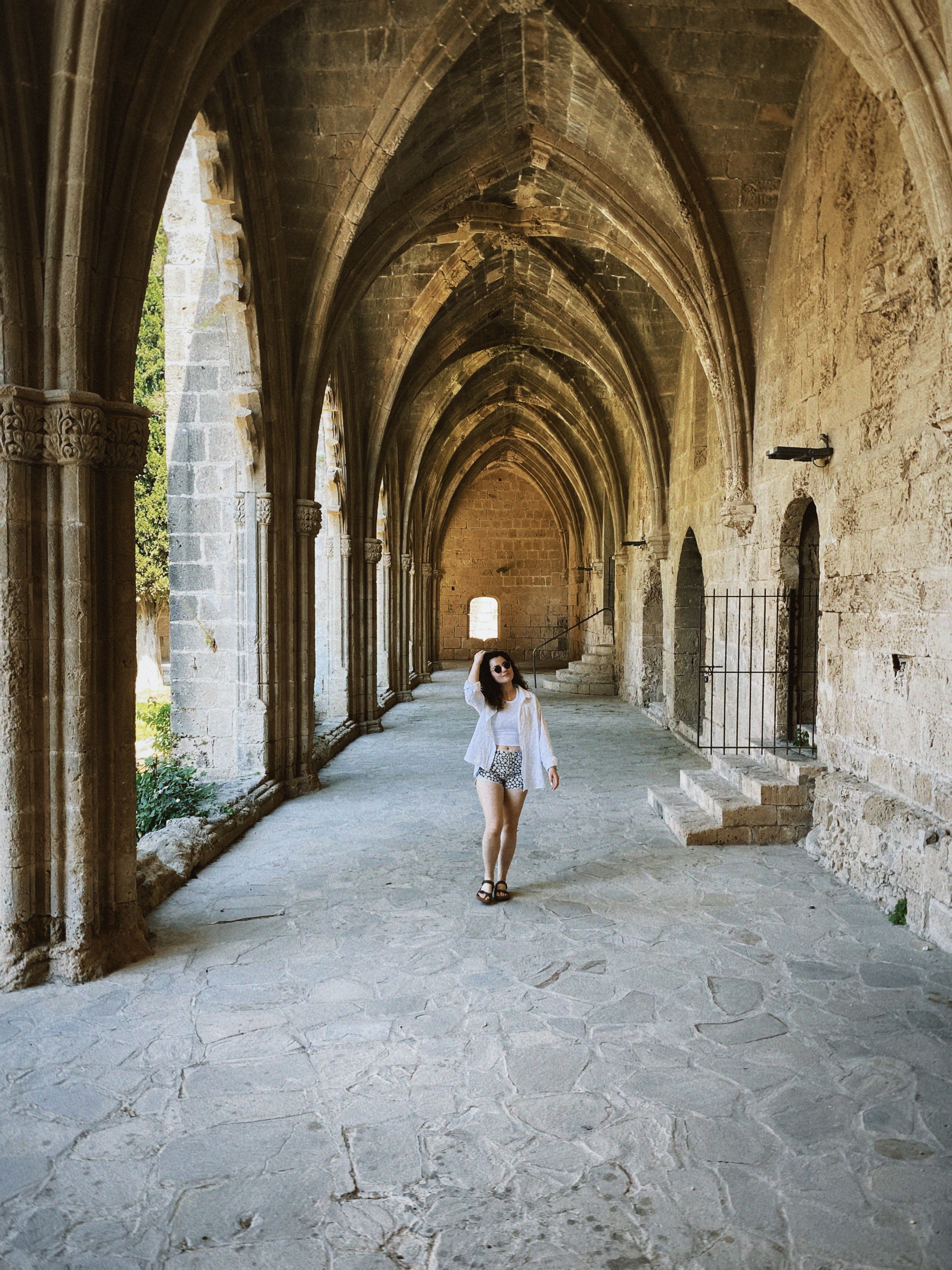 Woman Walking in Historic Gothic Archway · Free Stock Photo