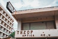 A vintage optical shop facade in Famagusta, Cyprus with aged signage.