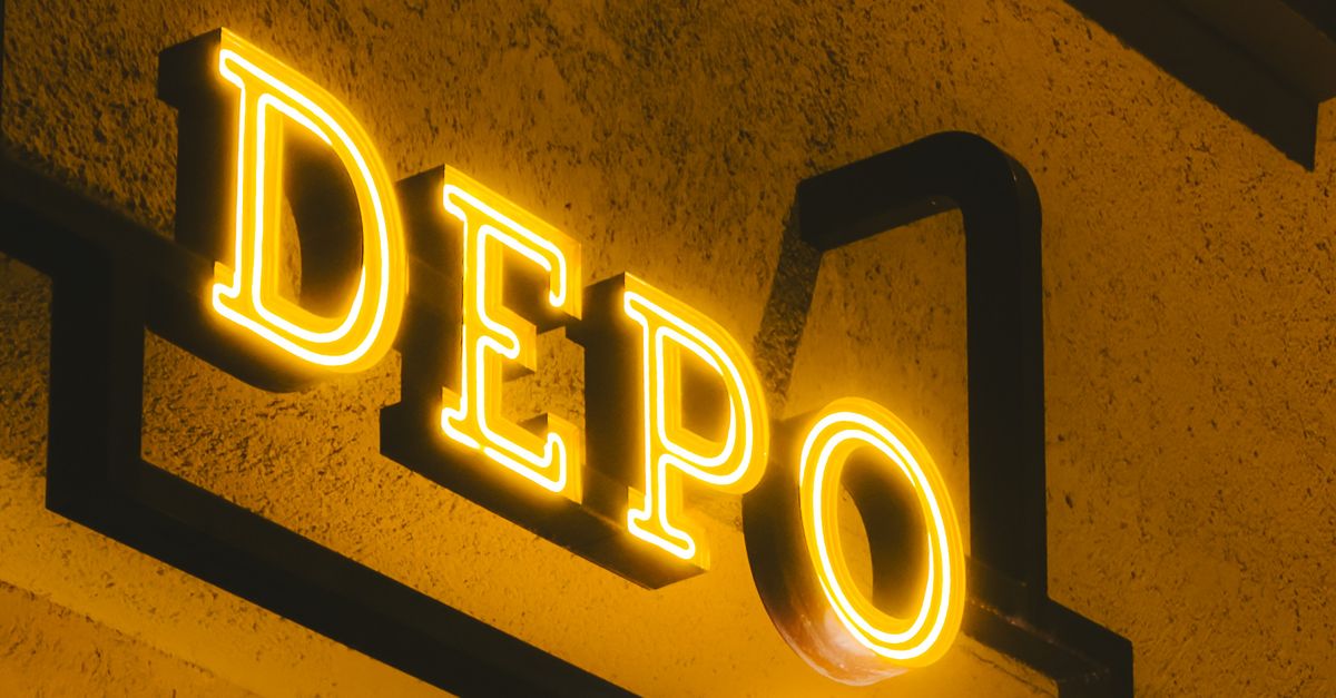 Illuminated DEPO Sign on Building at Night · Free Stock Photo