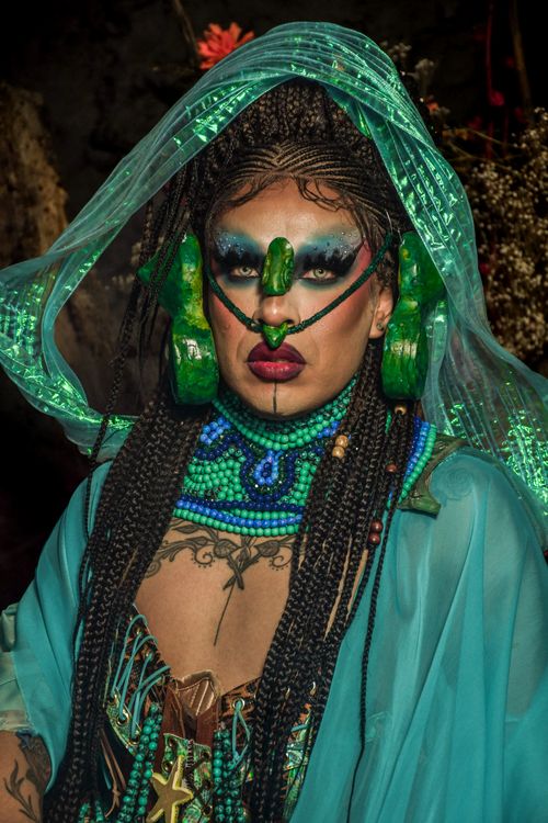 Free Striking portrait of an individual in ornate tribal attire with vivid makeup. Stock Photo