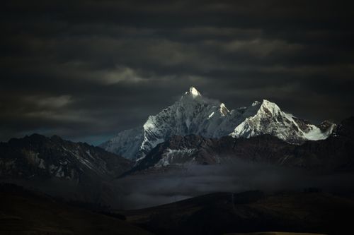Free Captivating view of the snow-capped Andes Mountains under a moody evening sky in Cusco, Peru. Stock Photo