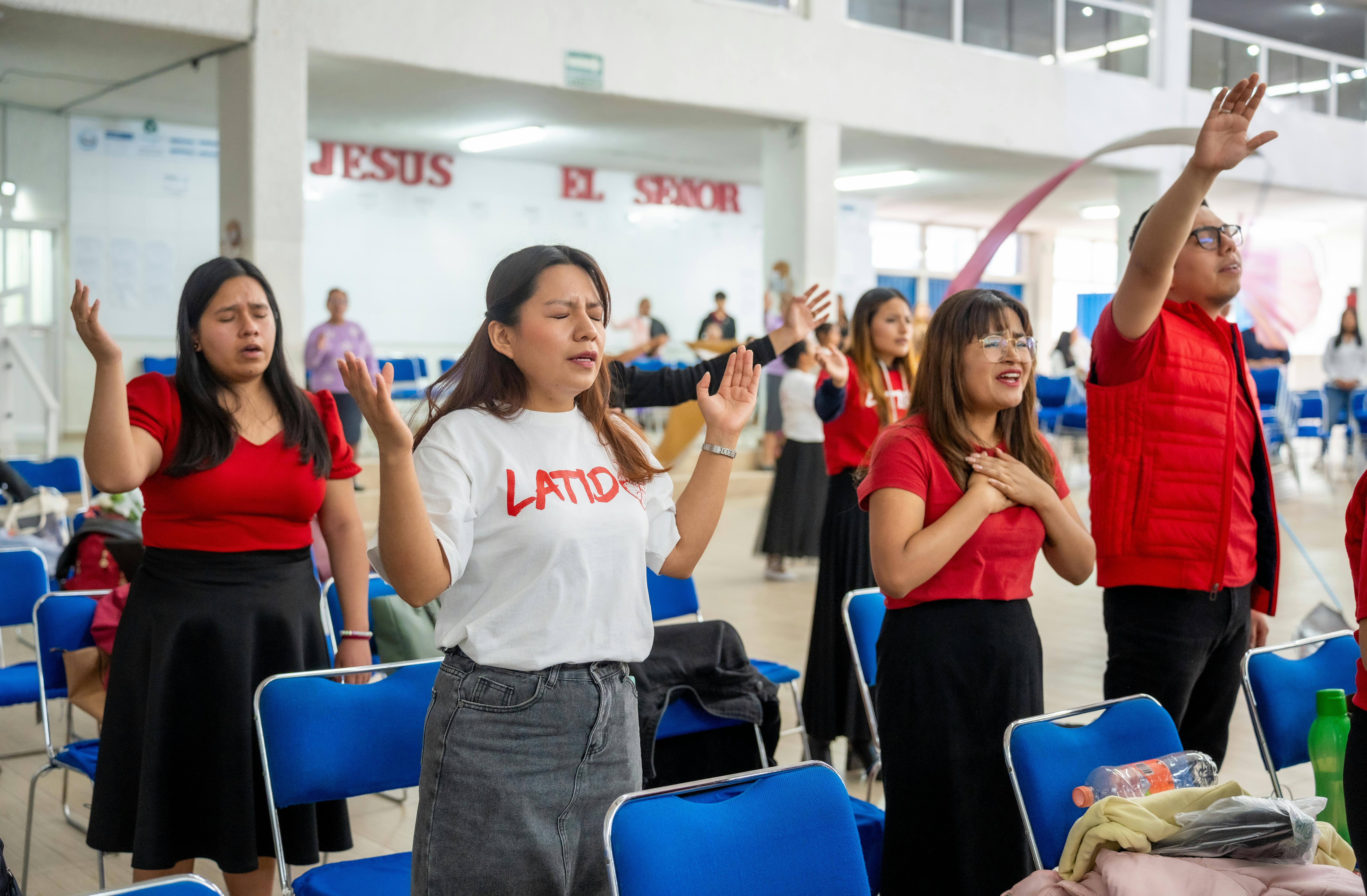 young adults worshipping at church in mexico city