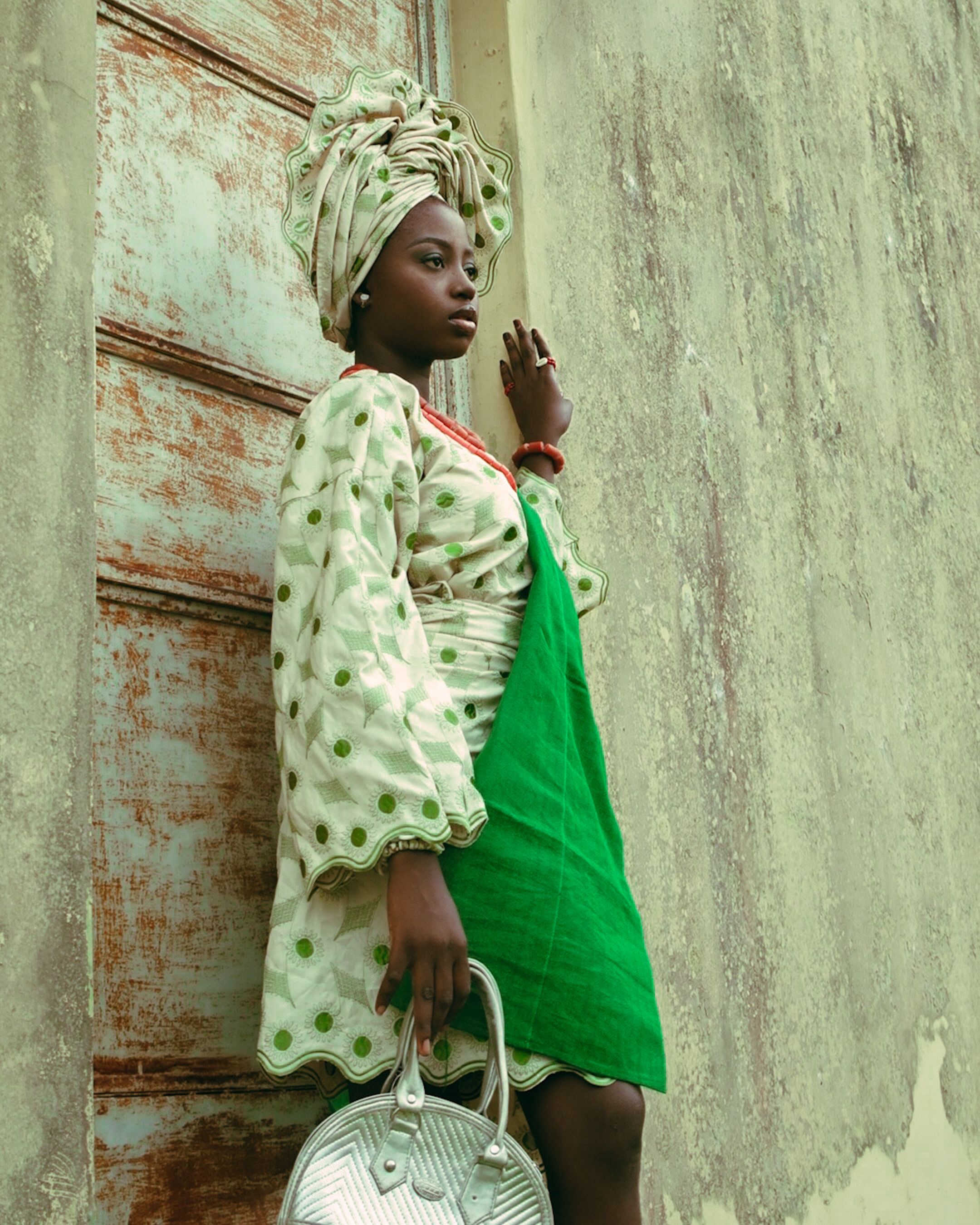 Beautiful African woman in vibrant traditional clothing, striking a stylish pose.