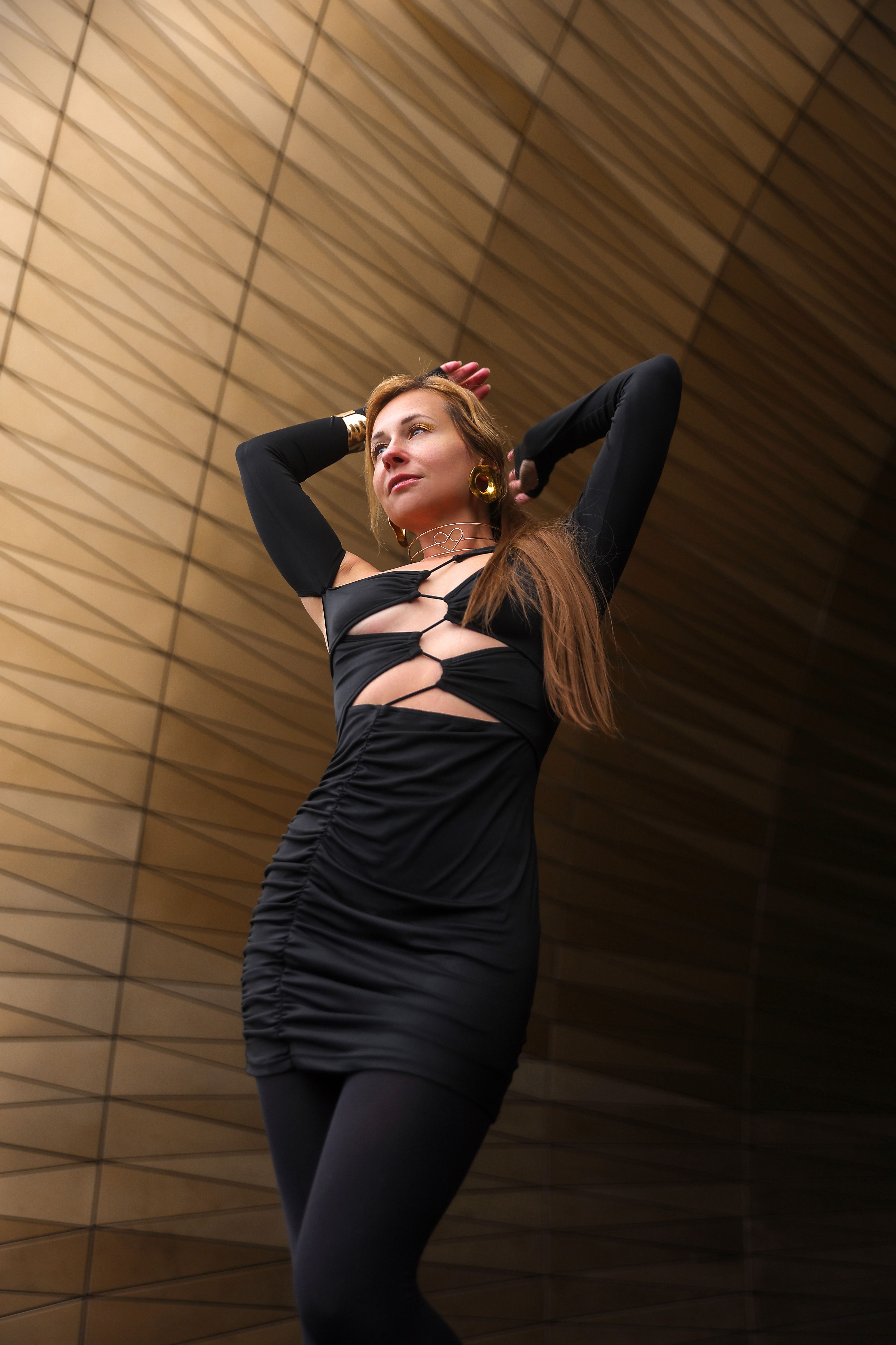 Elegant Woman Posing in Modern Architectural Setting · Free Stock Photo