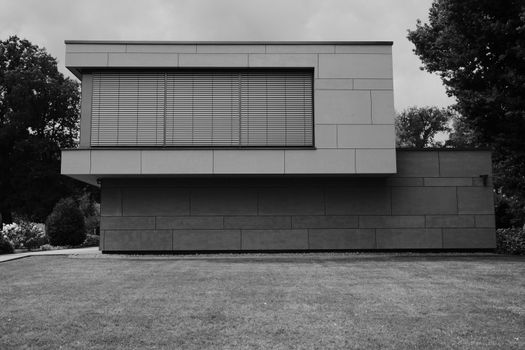 Black and white photo of a modern minimalist house with a geometric facade.