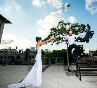 Bride and groom celebrating outdoors with a bouquet toss in Tel Aviv-Yafo.