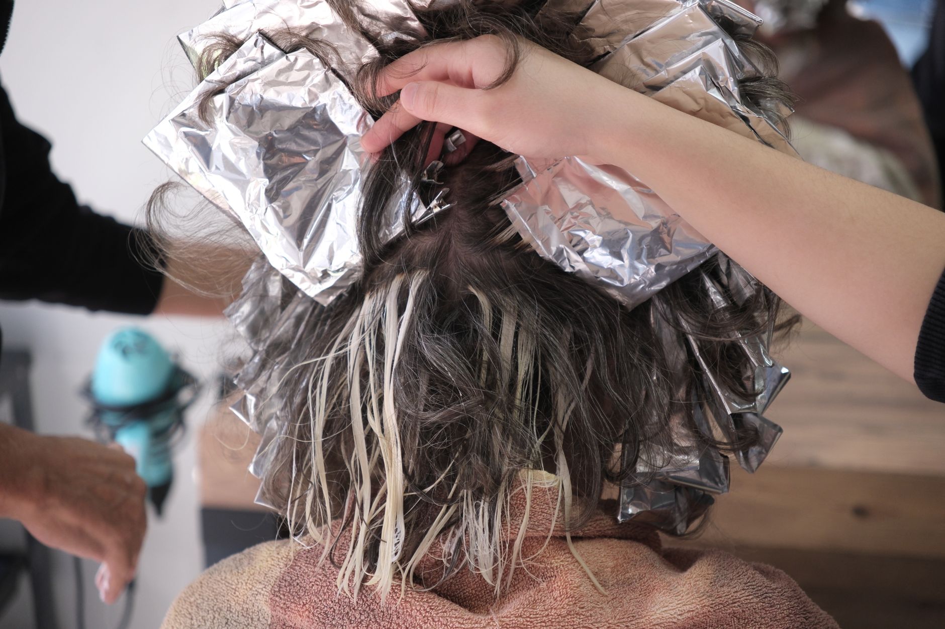 Bright blonde hair after a color session, glossy and even, salon lighting