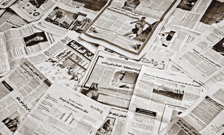 A collection of Arabic newspapers spread across a surface, showcasing diverse headlines and articles