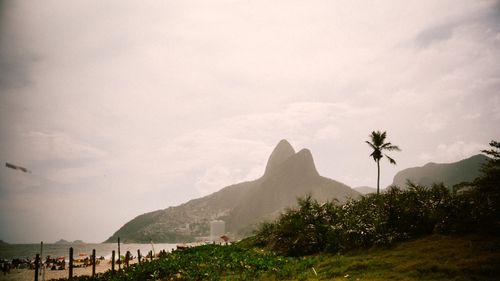 Free A serene view of Ipanema Beach with the iconic Two Brothers Mountain in Rio de Janeiro. Stock Photo