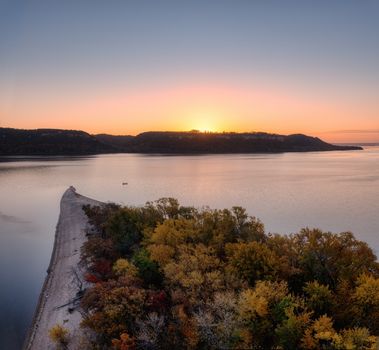 A breathtaking sunrise over Lake Pepin with vibrant autumn foliage, captured in Frontenac, Minnesota.
