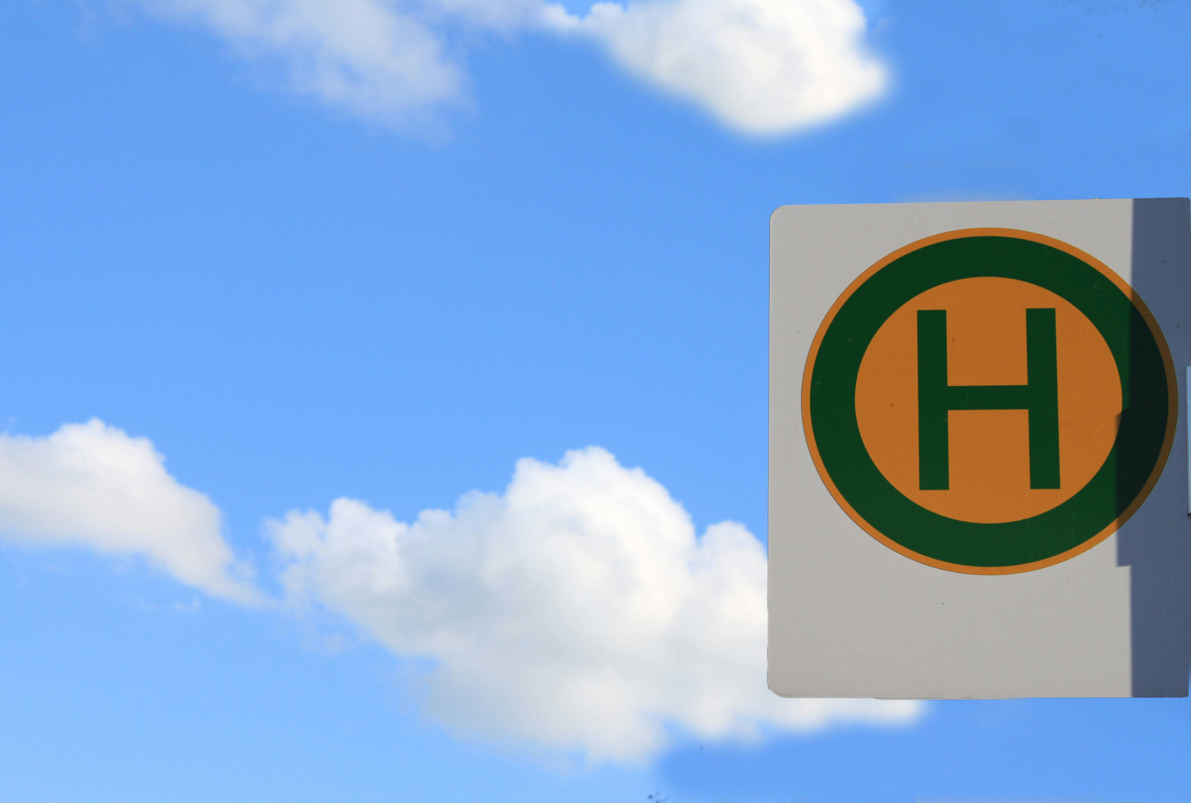 bus stop sign against clear blue sky