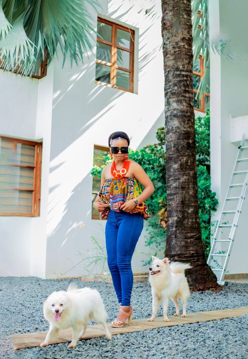 Free Fashionable woman with two white dogs outdoors by modern architecture. Stock Photo