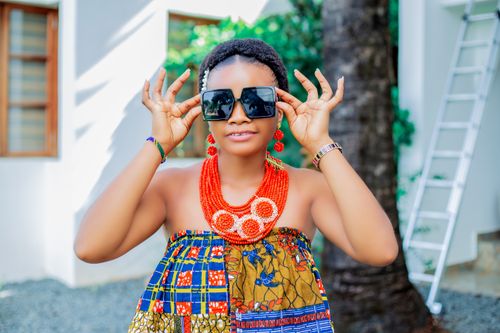 Free Beautiful woman wearing traditional African attire and sunglasses. Stock Photo