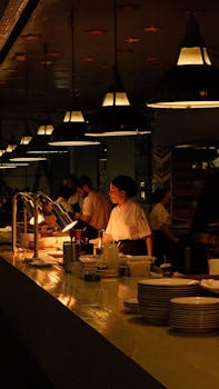 Diverse chefs work late night in Tbilisi's open kitchen, showcasing teamwork.