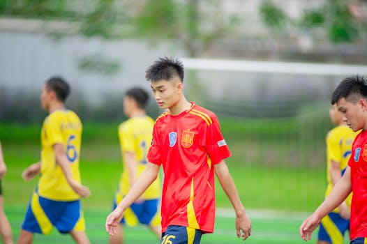 Young athletes in a soccer game at a field in Hanoi, Vietnam.