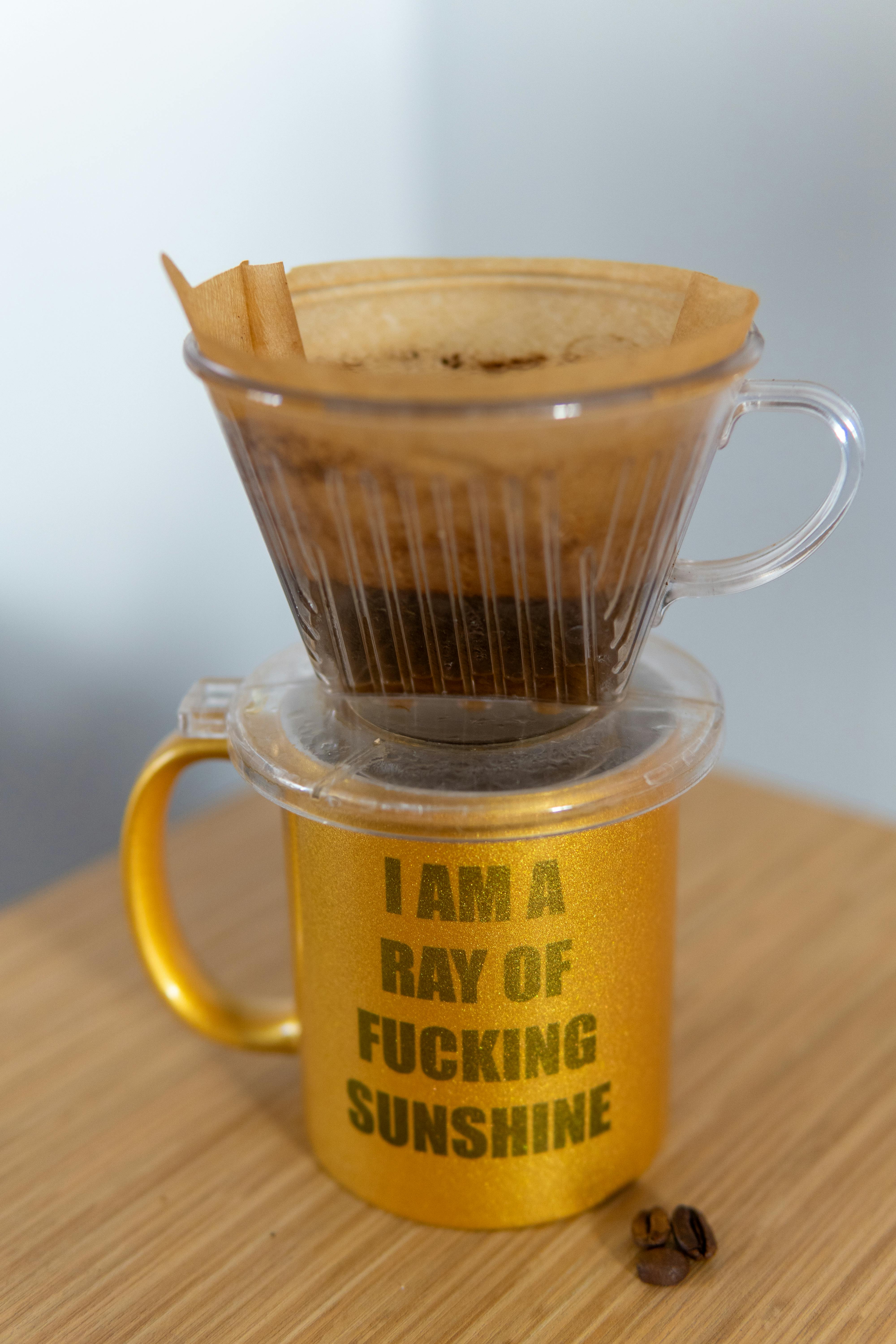 golden coffee cup with drip filter setup