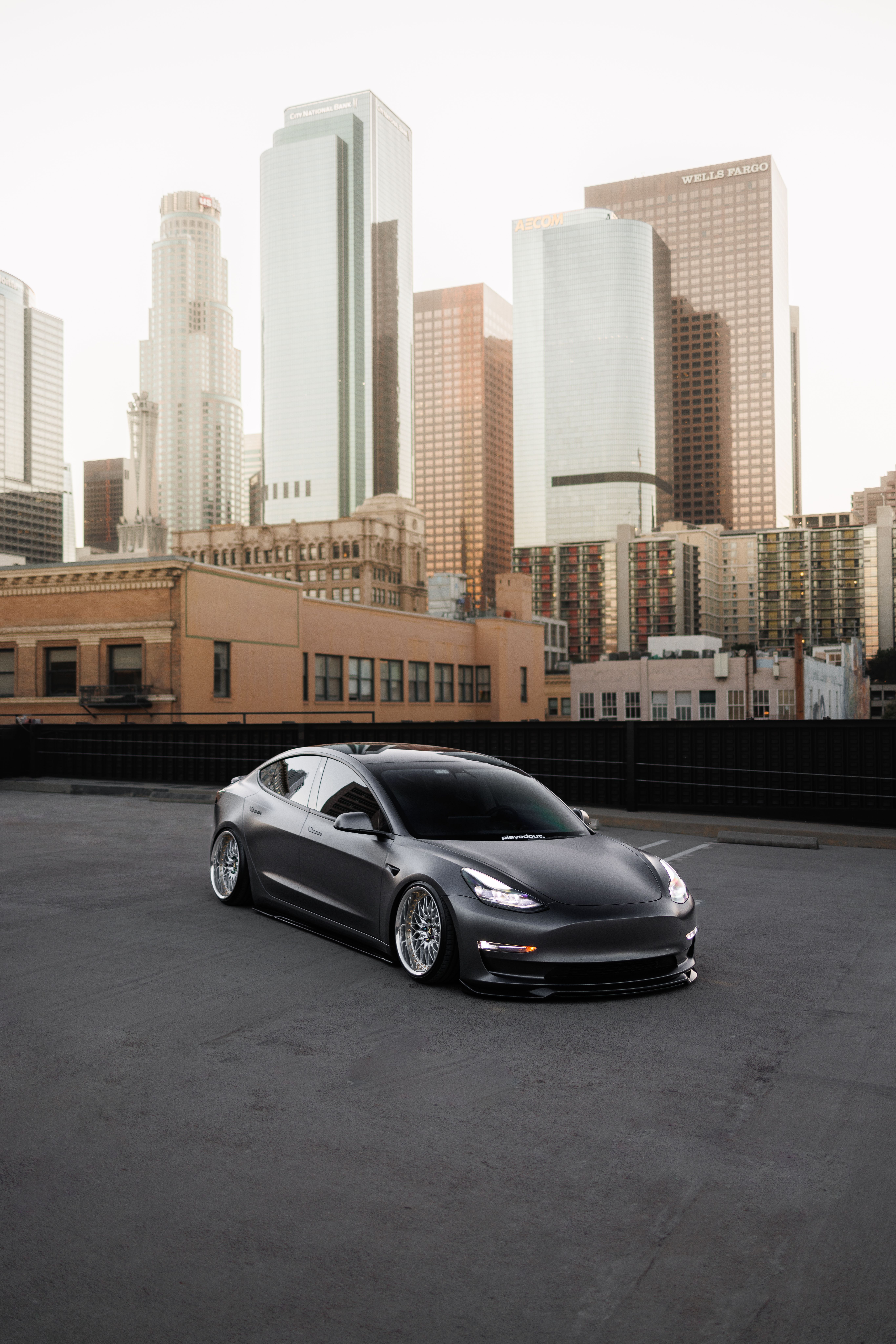 Tesla Car with Los Angeles Skyline at Sunset · Free Stock Photo