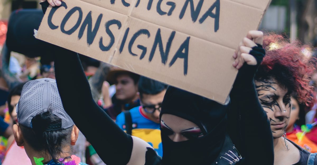 Colorful Street Protest with Sign and Colorful Attendees · Free Stock Photo