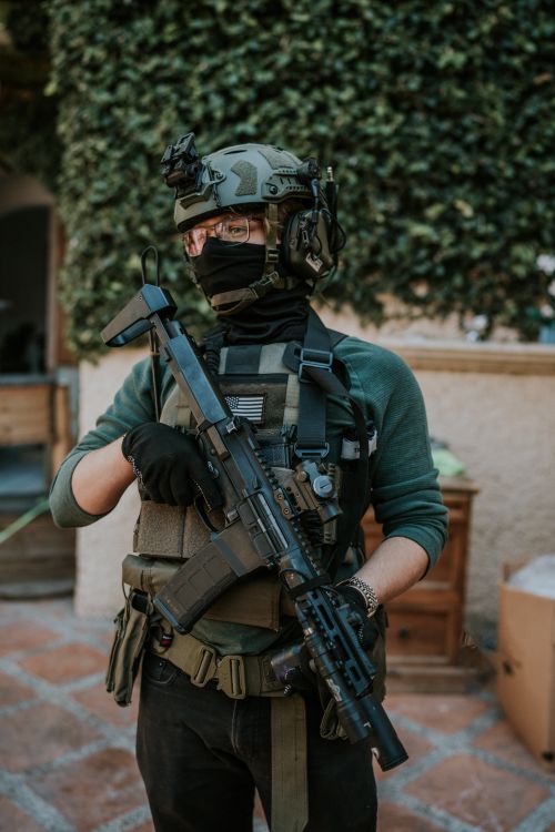 Free A tactical soldier in full gear poses with firearm outdoors, ready for action. Stock Photo