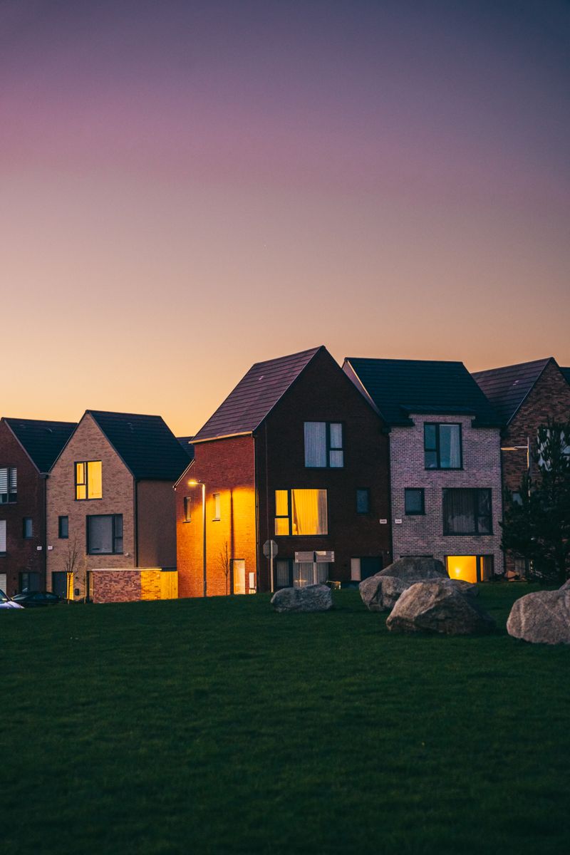 Suburban houses under a twilight sky, photo by Selim Karadayi on Pexels