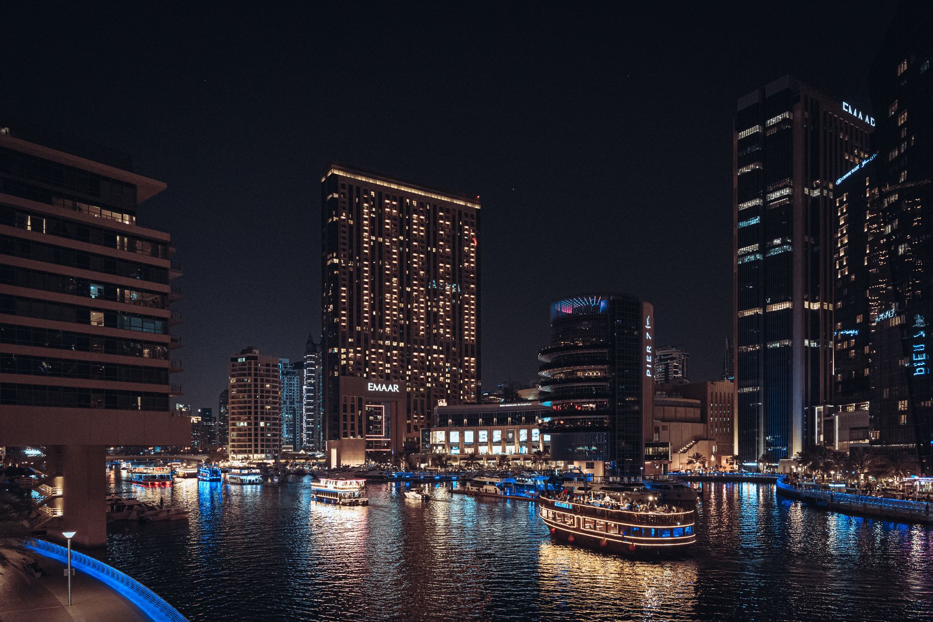Stunning night view of Dubai Marina, showcasing illuminated skyscrapers and vibrant reflections on t