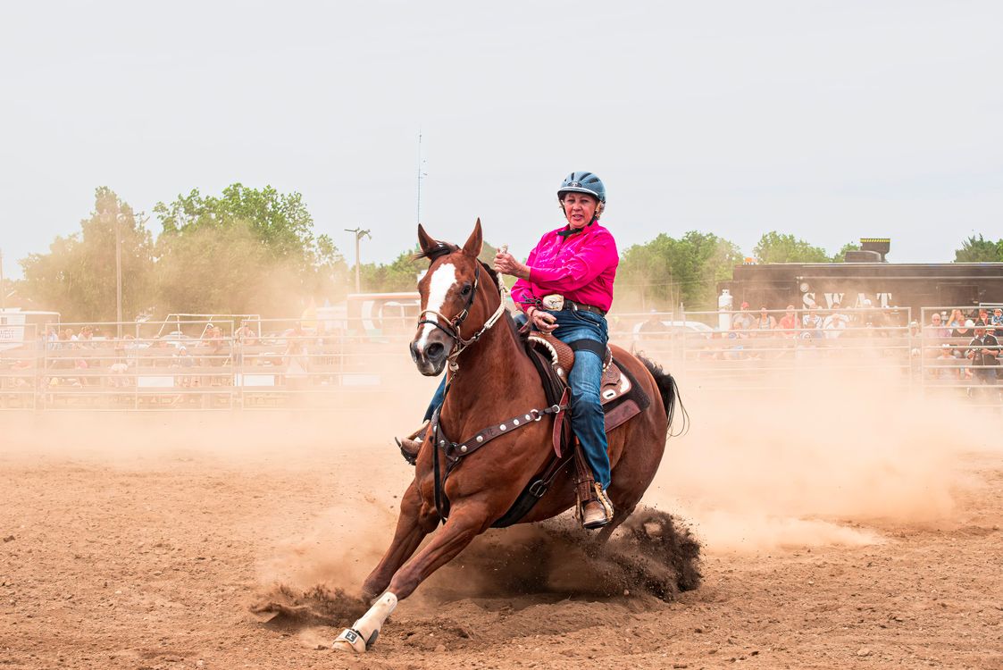 Dynamic Rodeo Rider in Action at Outdoor Arena · Free Stock Photo