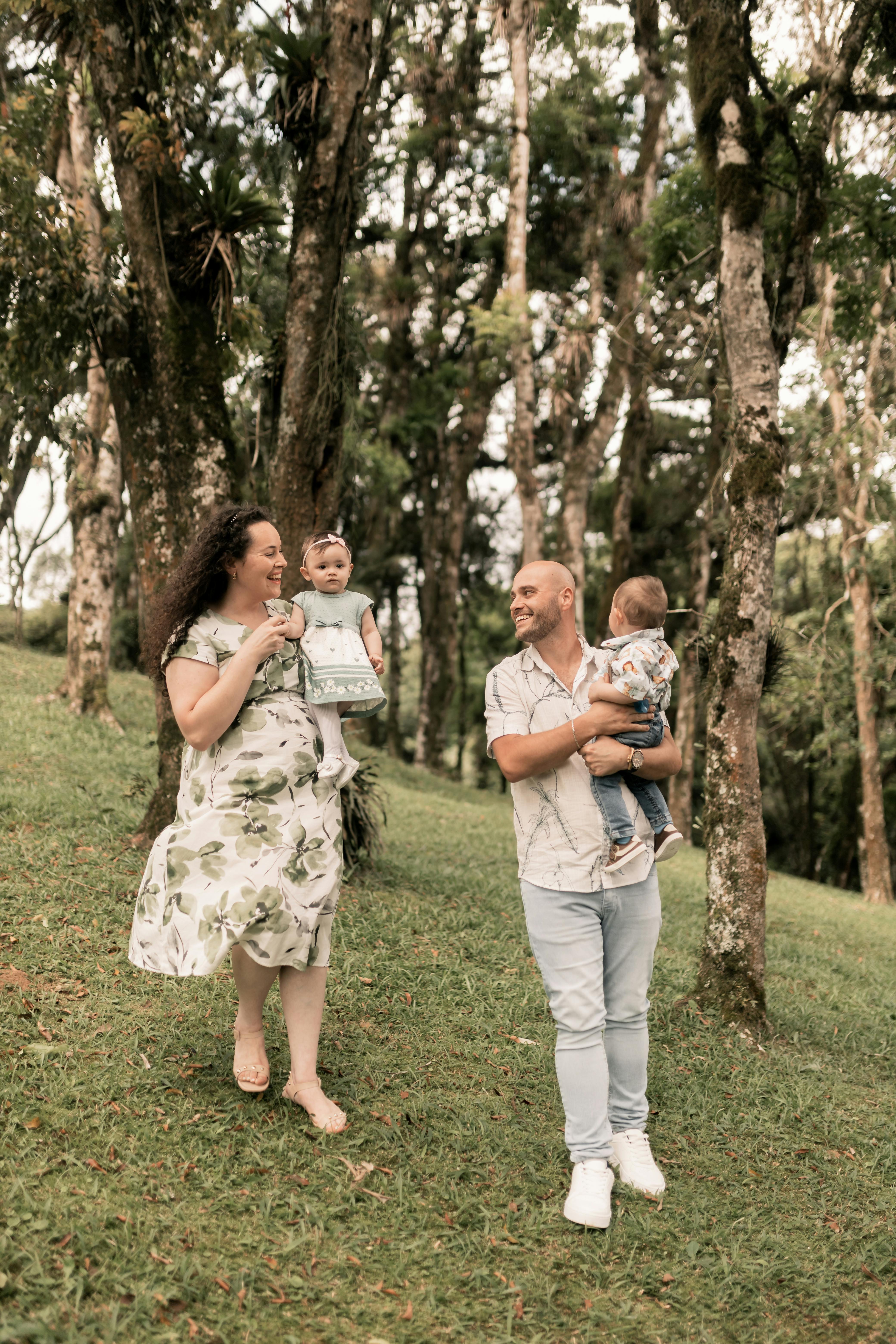 A joyful family enjoying a walk in a lush forest setting, embracing nature.