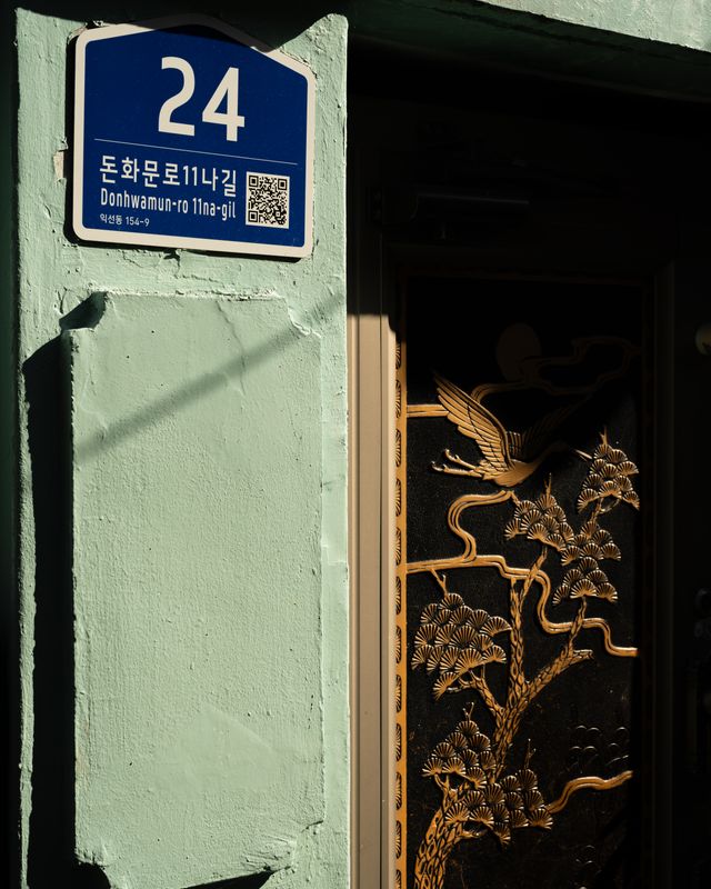 Donhwamun-ro street address beside a traditional Seoul door