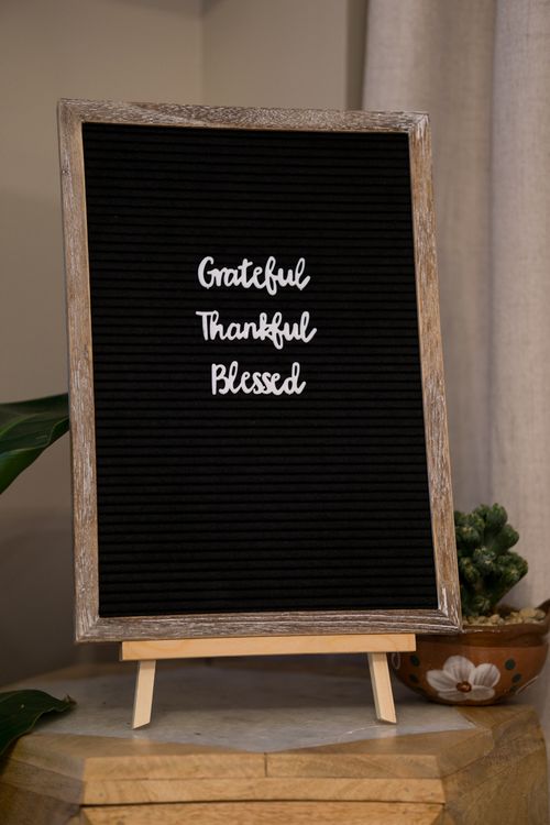 Free Blackboard featuring the words 'Grateful Thankful Blessed' in a cozy interior setting. Stock Photo