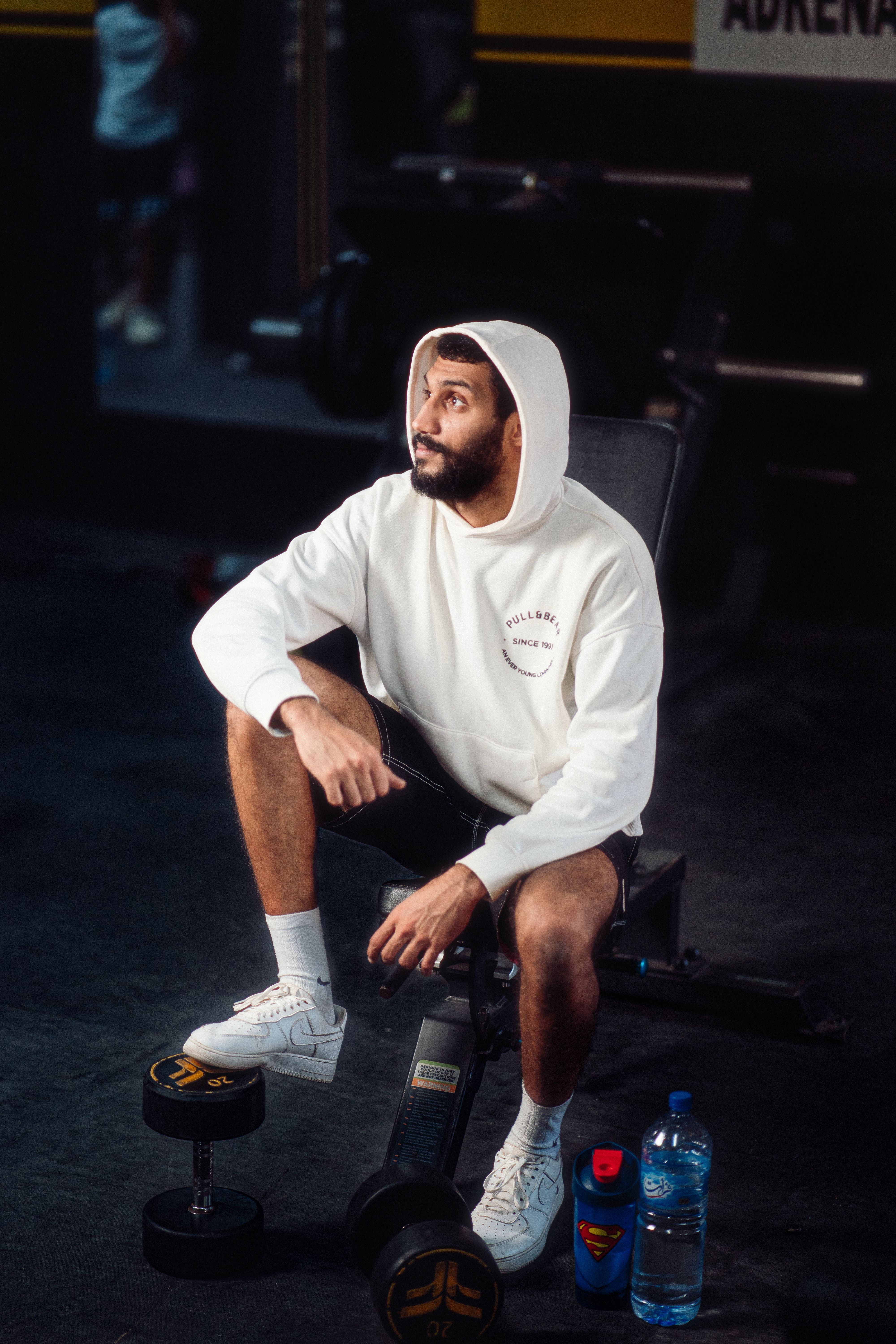 Athlete resting in hooded gym wear