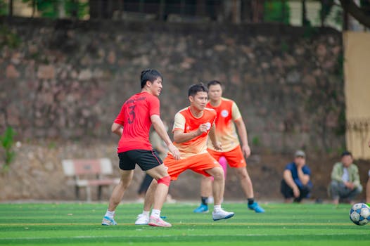 Amateur football match at a local field in Hà Nội, showcasing teamwork and sportsmanship.