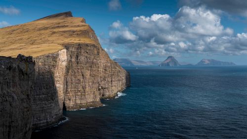 Free Breathtaking view of majestic sea cliffs and ocean in the Faroe Islands under beautiful clouds. Stock Photo
