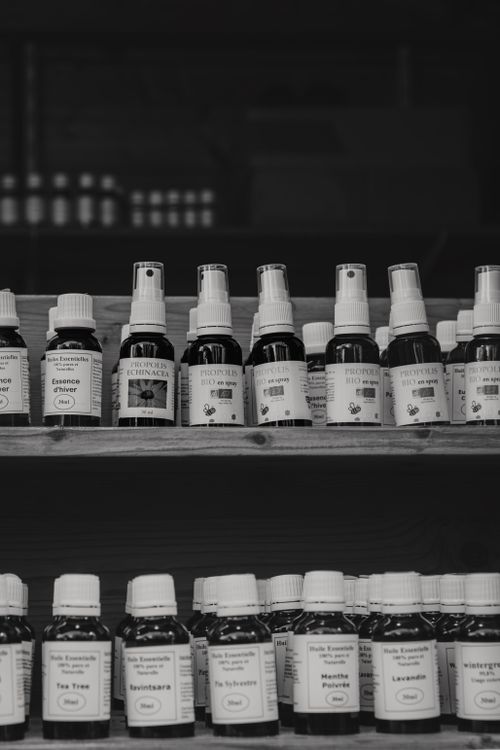 Free A black and white image of natural health products on wooden shelves at a market. Stock Photo