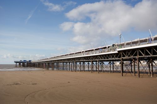 Free View of the Grand Pier in Weston-super-Mare, showcasing its architecture on a sunny day at low tide. Stock Photo