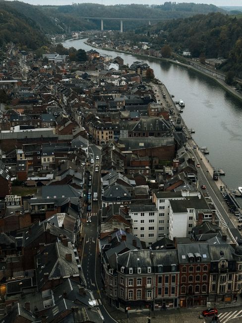 Stunning aerial view of Dinant, Belgium, showcasing the city's historic rooftops and the Meuse River.