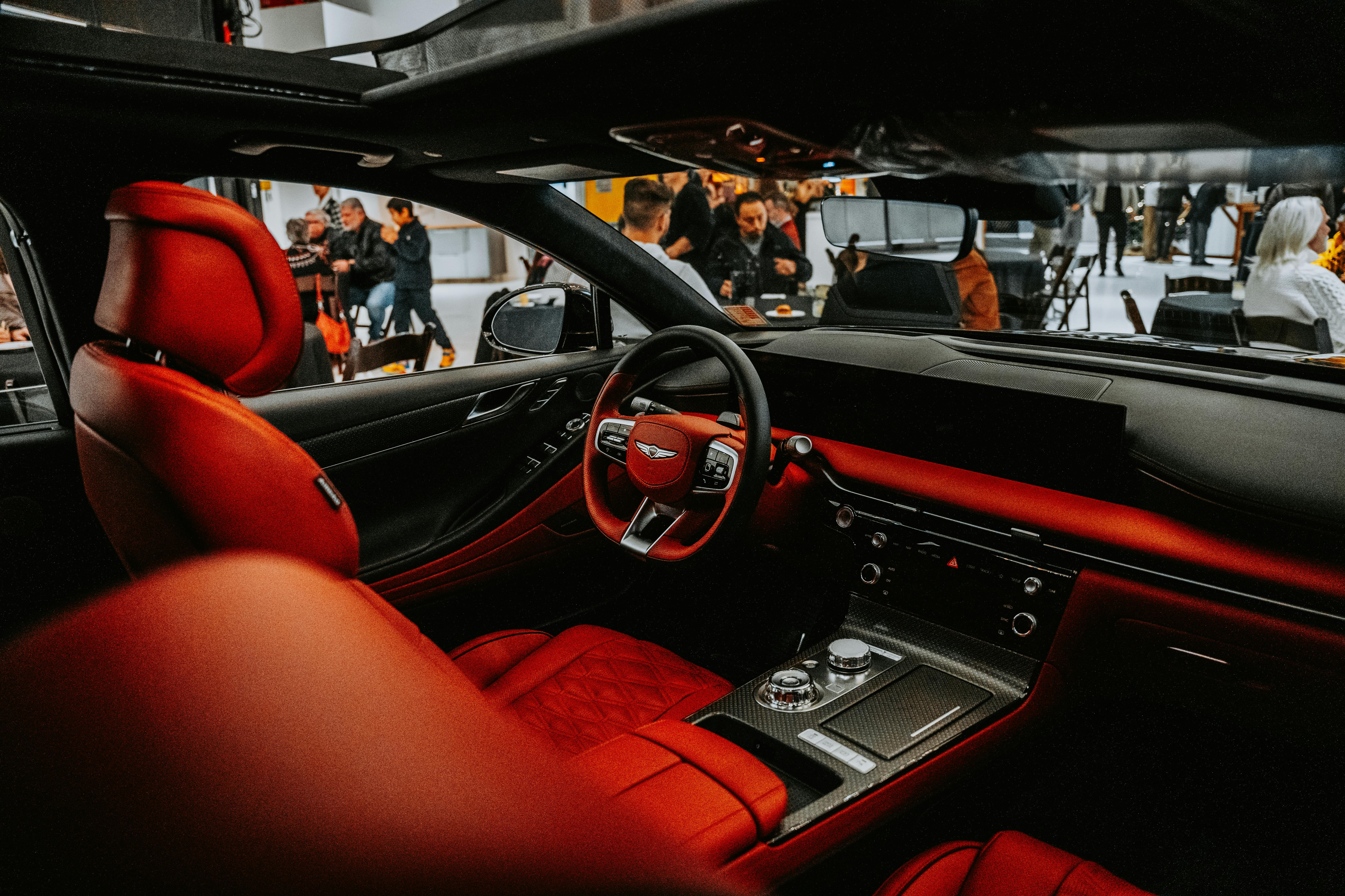Explore the luxury of a high-end car interior with vibrant red leather seats and advanced controls.