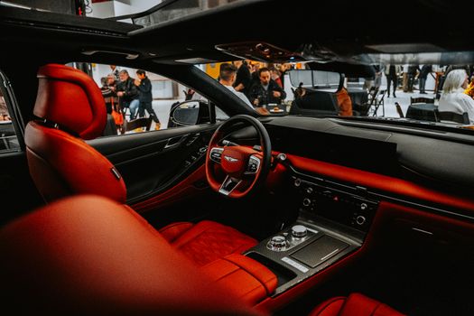 Explore the luxury of a high-end car interior with vibrant red leather seats and advanced controls.