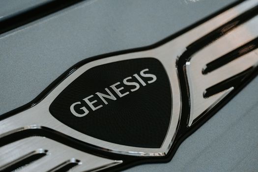 Detailed close-up of the Genesis car logo emblem for automotive branding. - Fotografer Sidoarjo