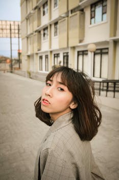 一位年轻女子在城市街头时尚地摆出户外造型，展现现代风格