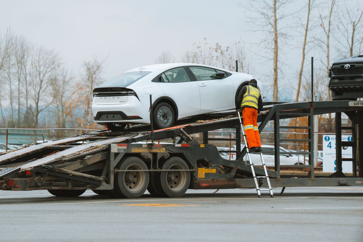Professional tow truck loading luxury vehicle - Emergency towing service by Eurobahn Collision Center