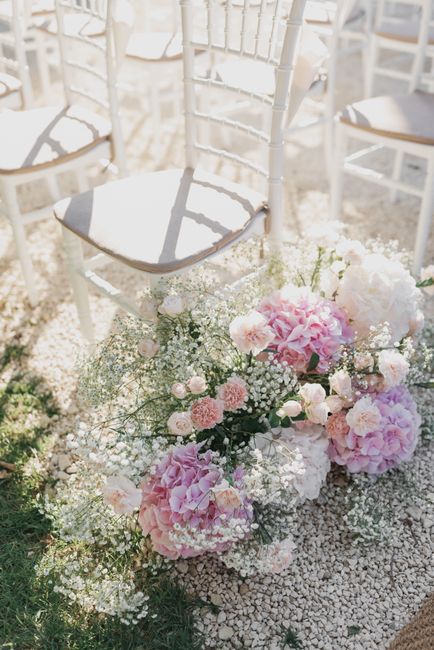 A beautiful floral arrangement with pink and white flowers for a wedding ceremony in Italy.