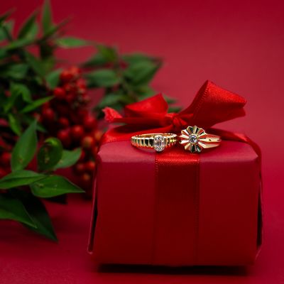 Two gold rings resting on a ribboned gift box — photo by archisude on Pexels
