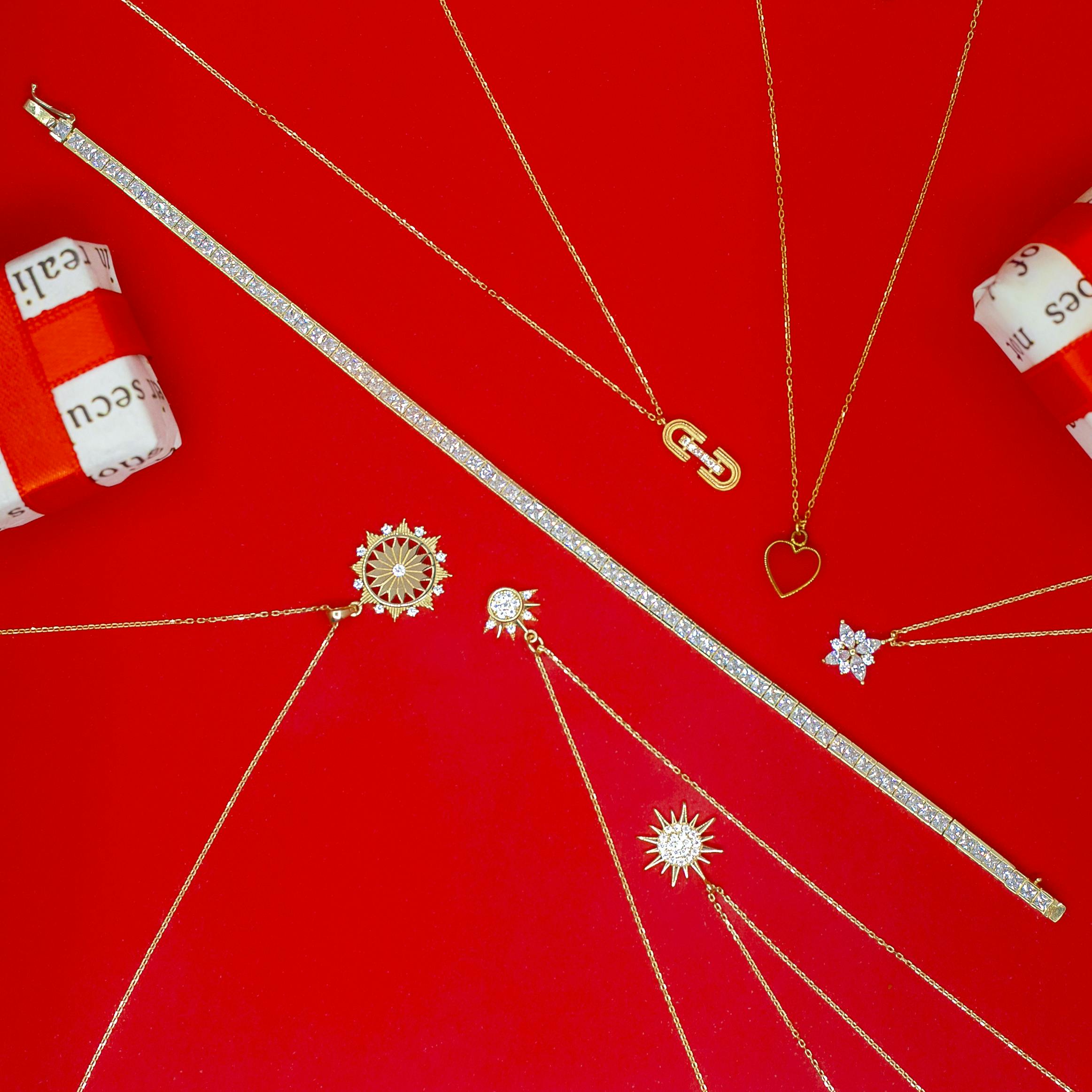 elegant gold jewelry on vibrant red background