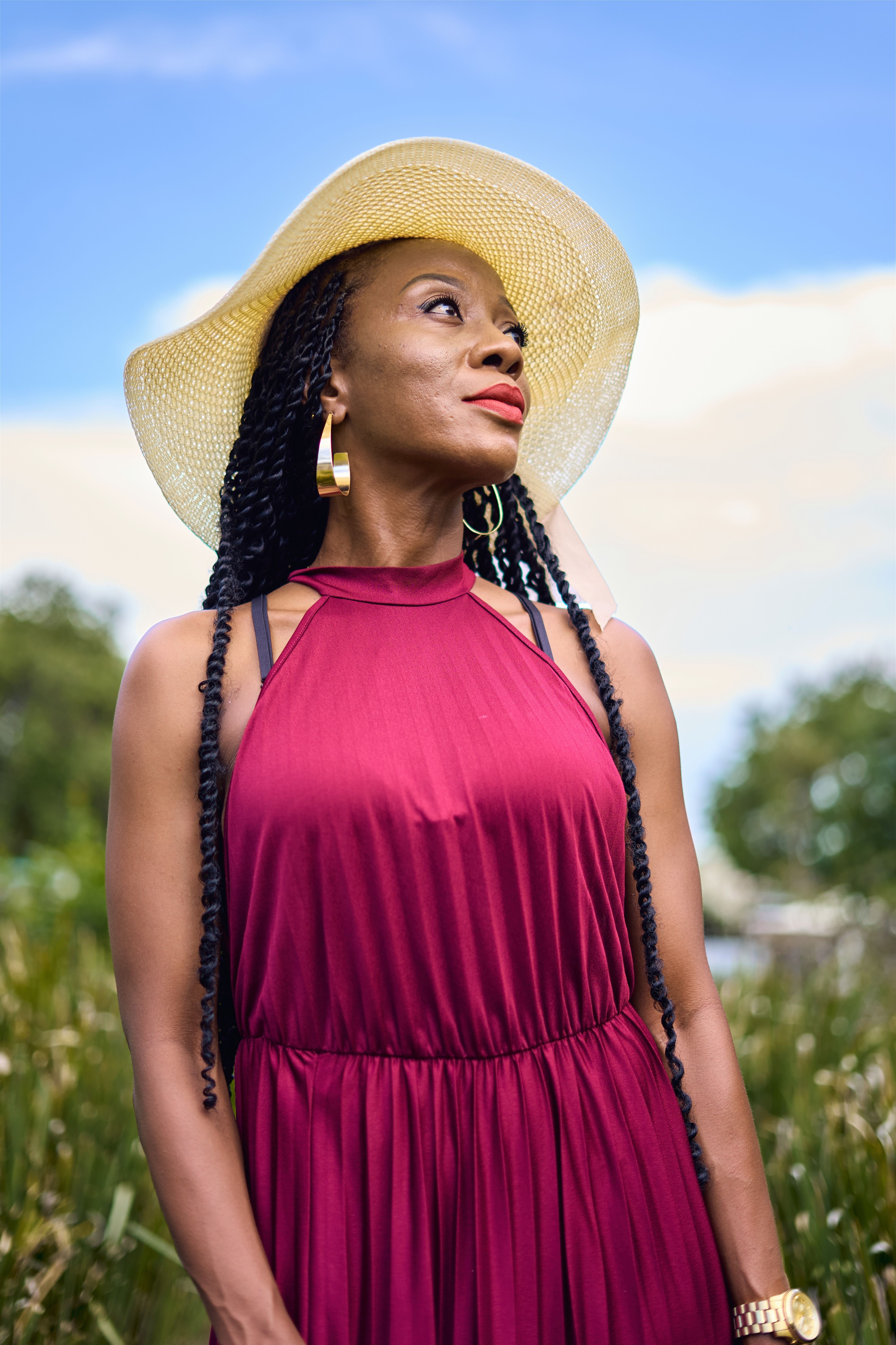 Woman in Burgundy Dress with Summer Hat Outdoors  Free Stock Photo