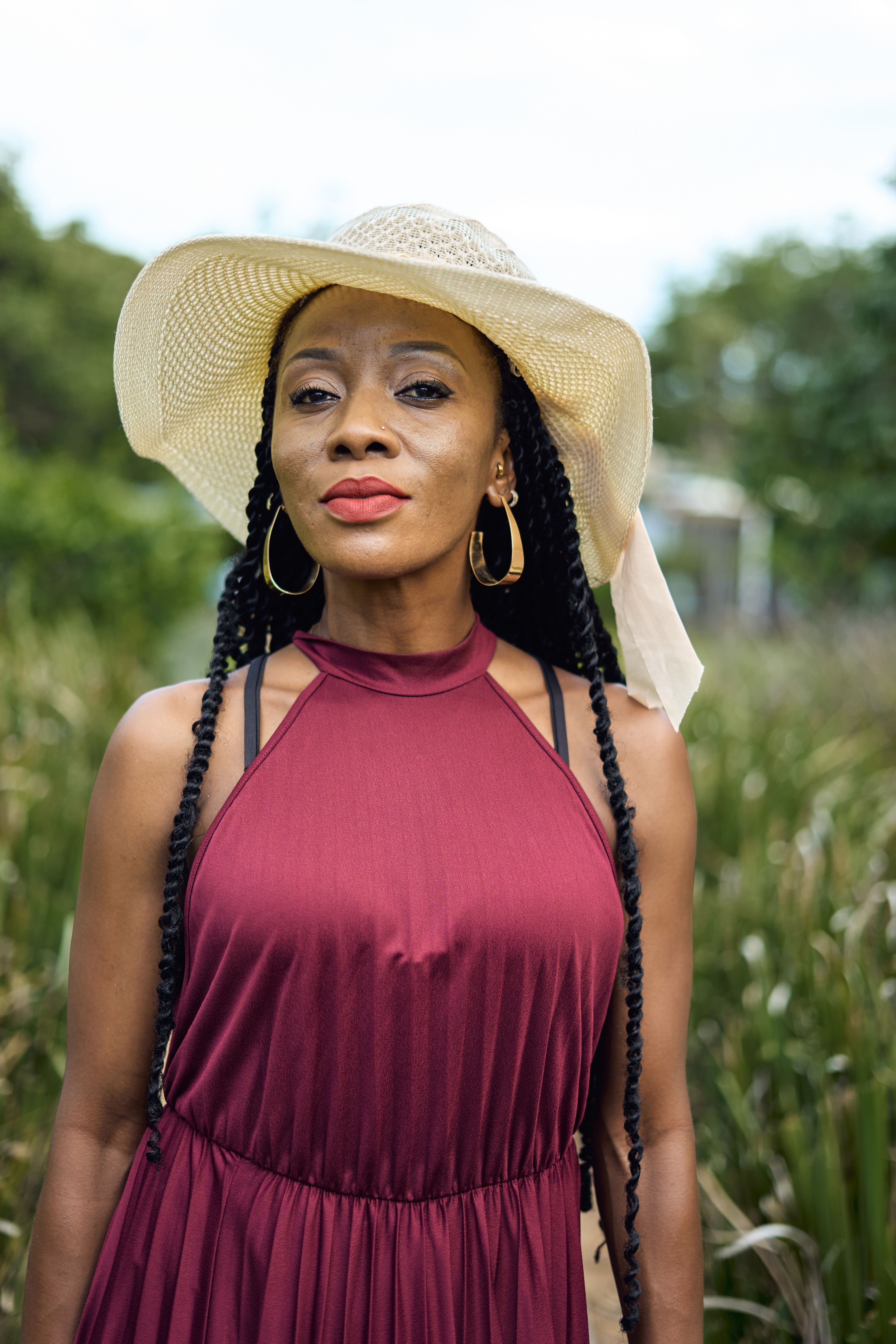 Elegant Woman in Burgundy Dress Outdoors  Free Stock Photo