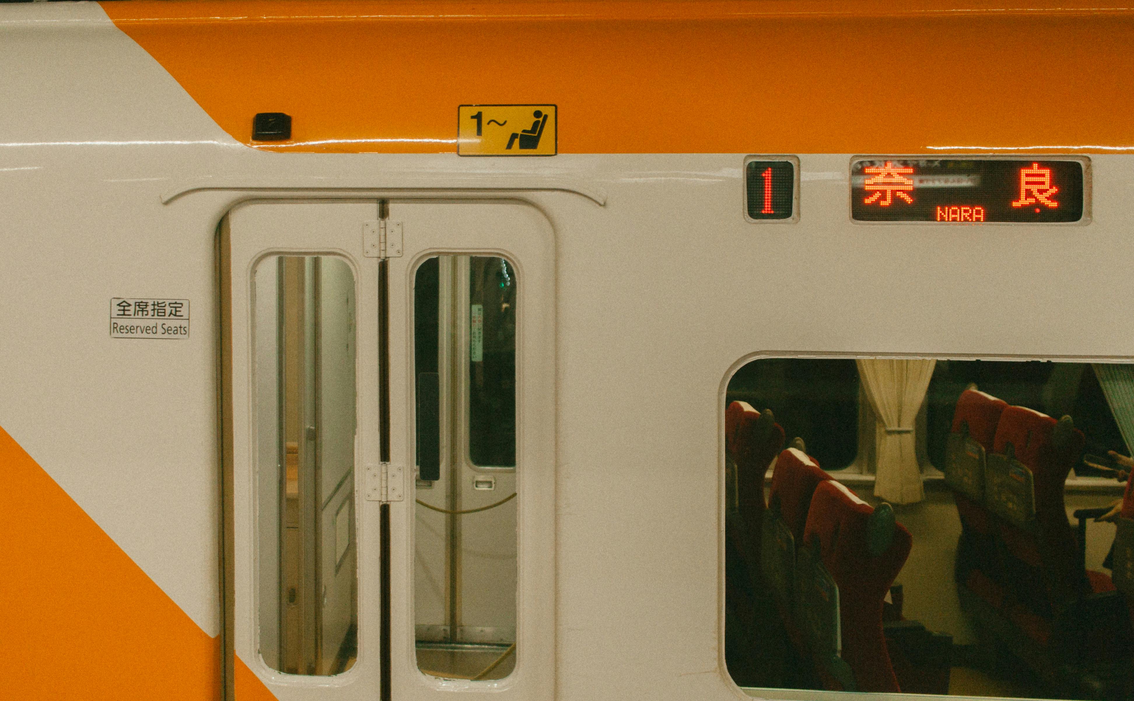Close-up of a train to Nara, Japan showcasing reserved seating signage.