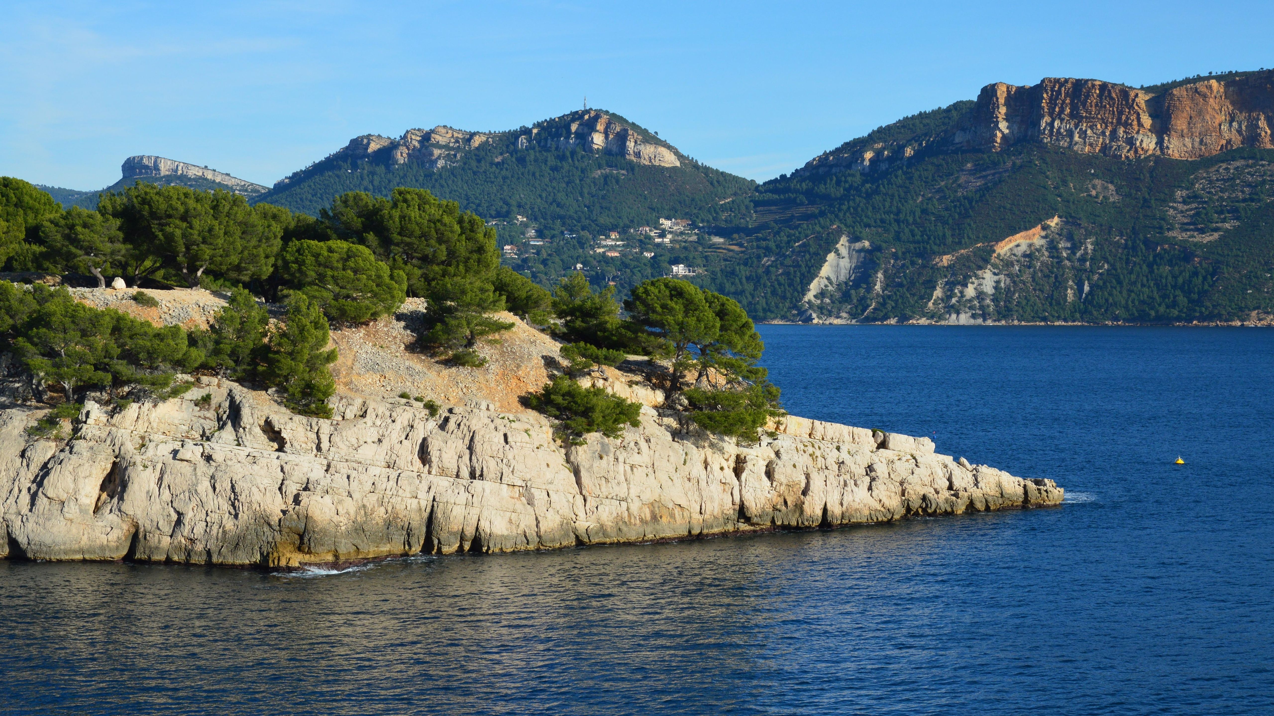 Breathtaking view of Cap Canaille and the rocky coast in Cassis, France under a clear blue sky. Breathtaking view of Cap Canaille and the rocky coast in Cassis, France under a clear blue sky.