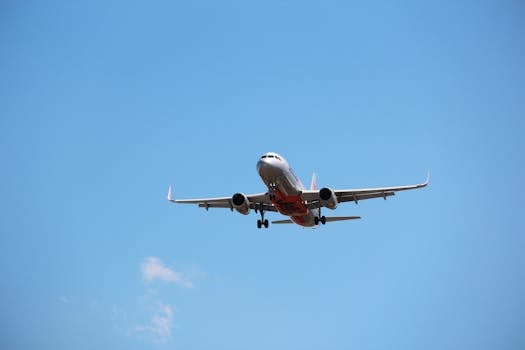 A Jetstar Airways plane landing at Melbourne Airport on a clear sunny day.