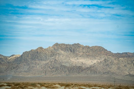 Stunning mountain landscape with clear blue sky, showcasing natural beauty and rugged terrain.