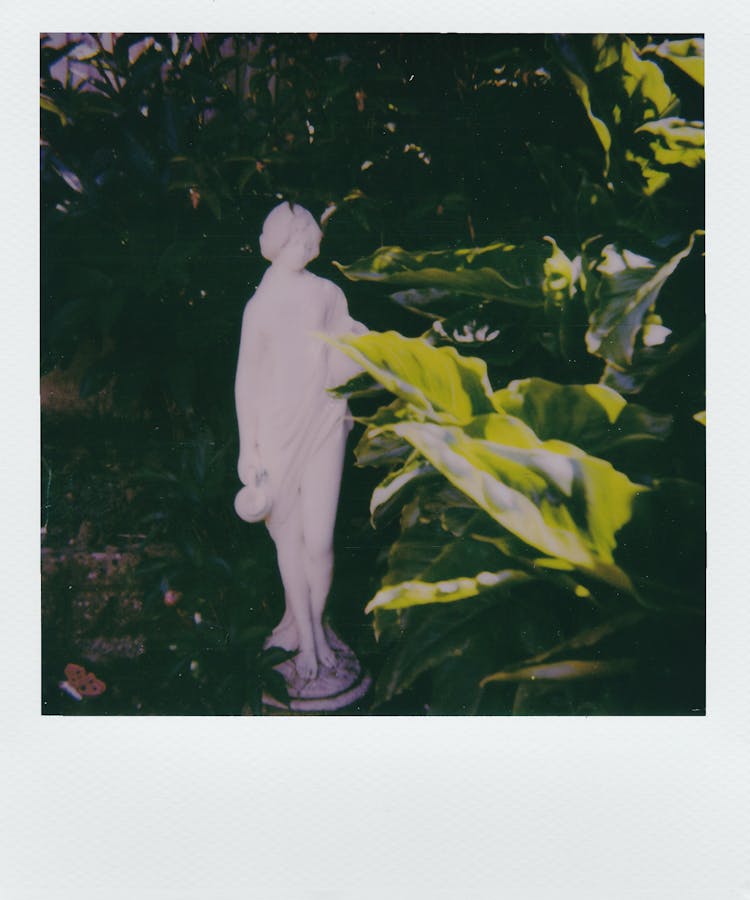 Ornamental Statue Of A Woman In The Garden